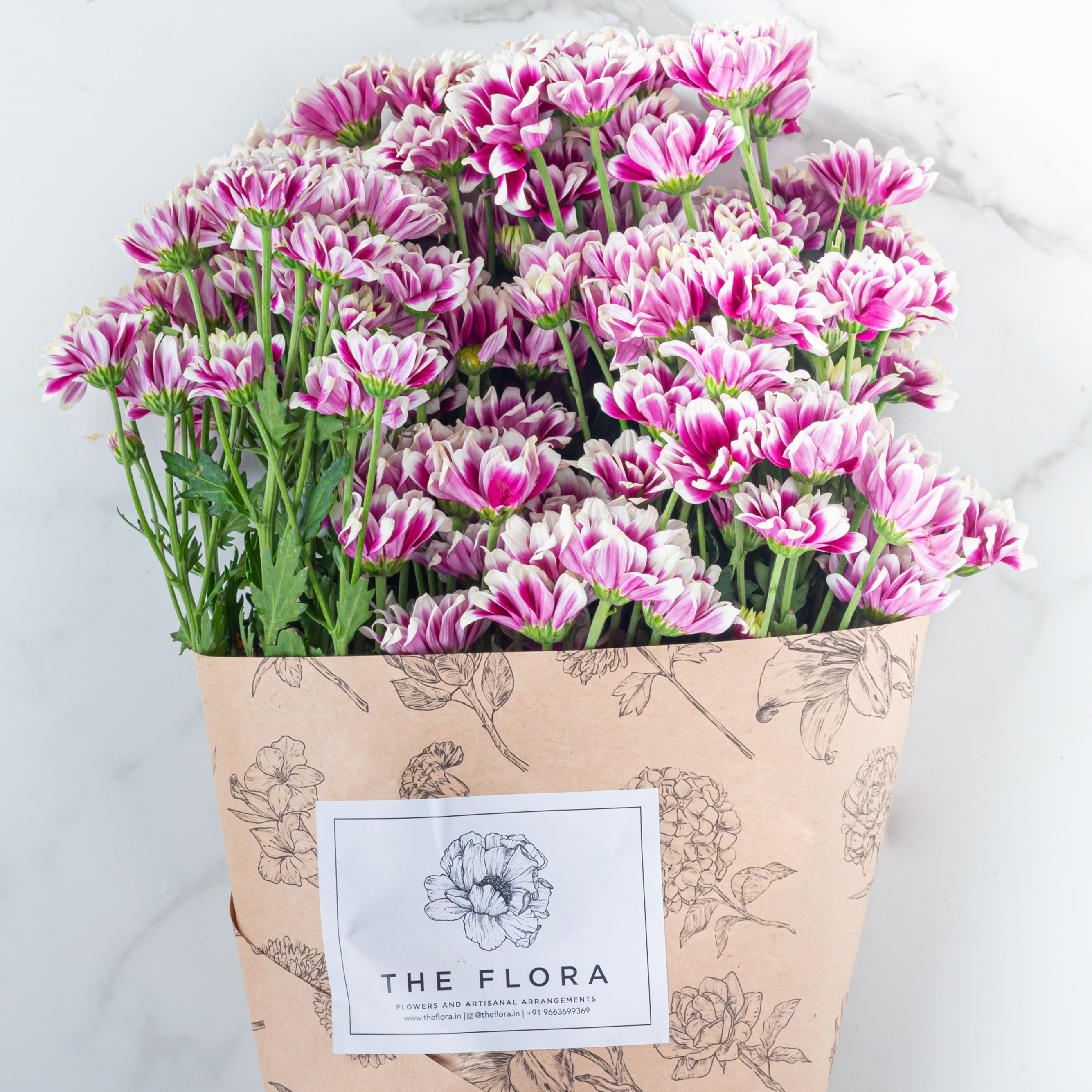 Bouquet of pink Santini Chrysanthemums from 'The Flora' a cut flower offering in sustainable packaging. Online cut flowers with same day delivery at www.theflora.in