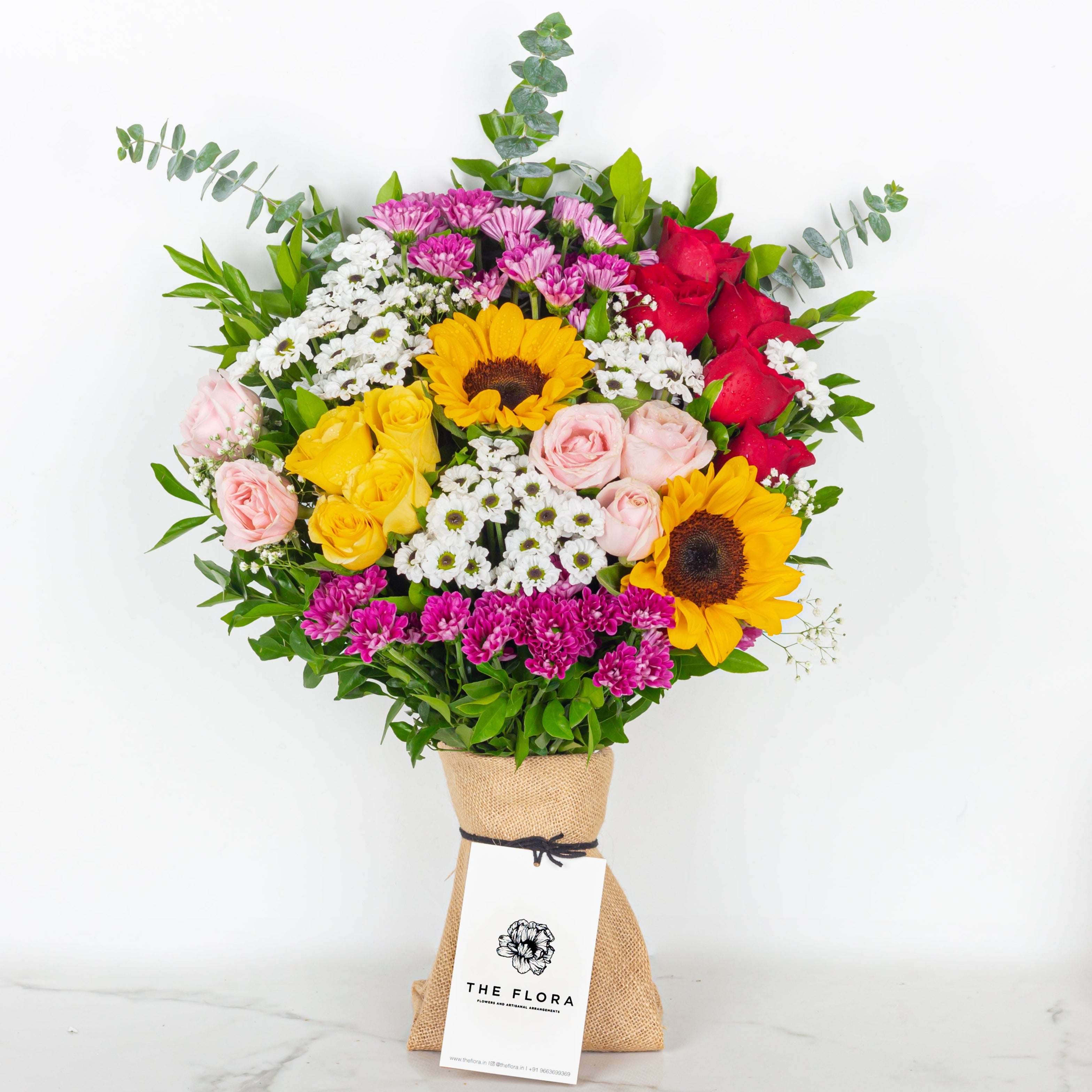 Bouquet of colorful flowers with a visible brand tag on a white background