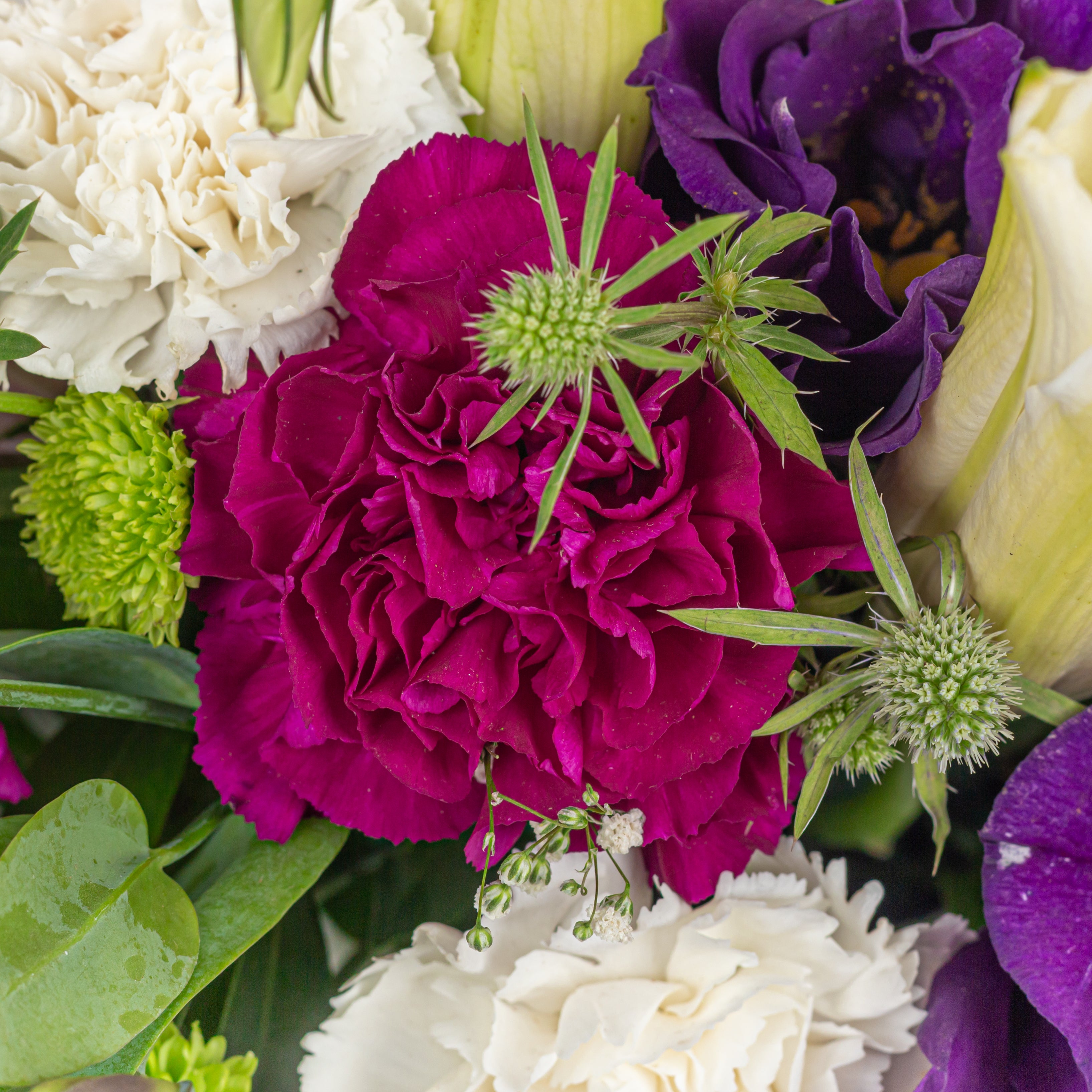 Oriental lilies eryngium thistle romantic flower arrangement metal pot