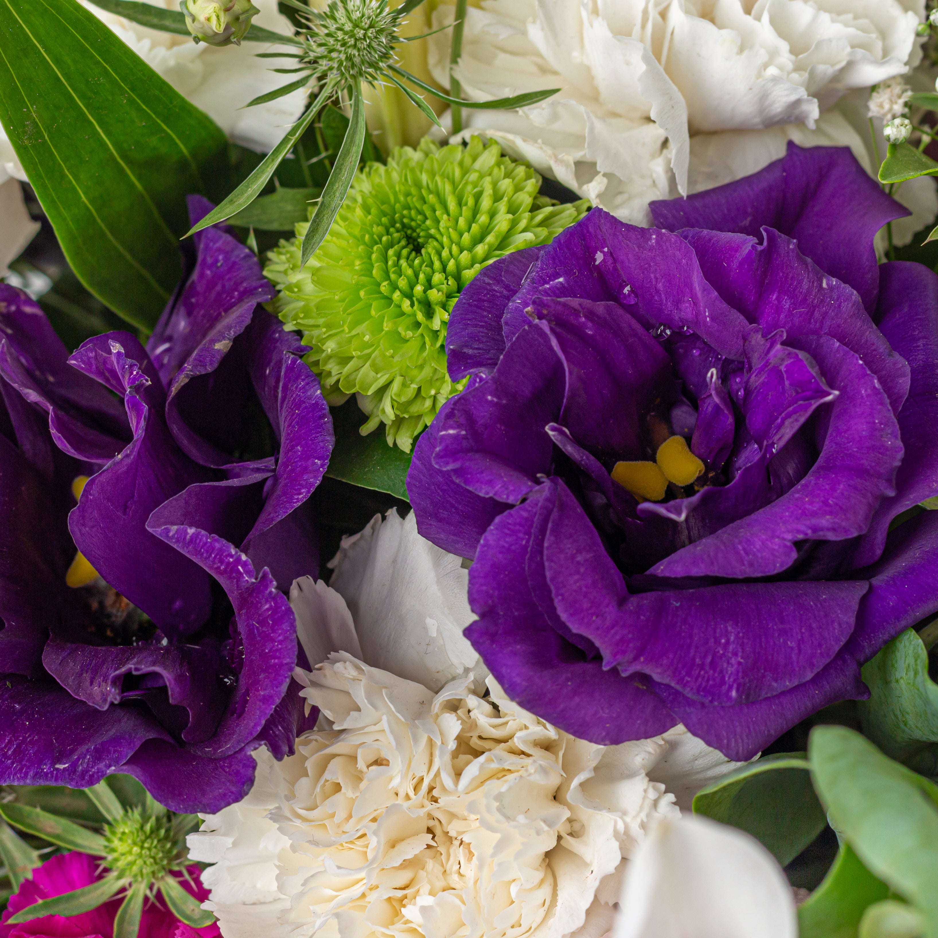 Oriental lilies eryngium thistle romantic flower arrangement metal pot
