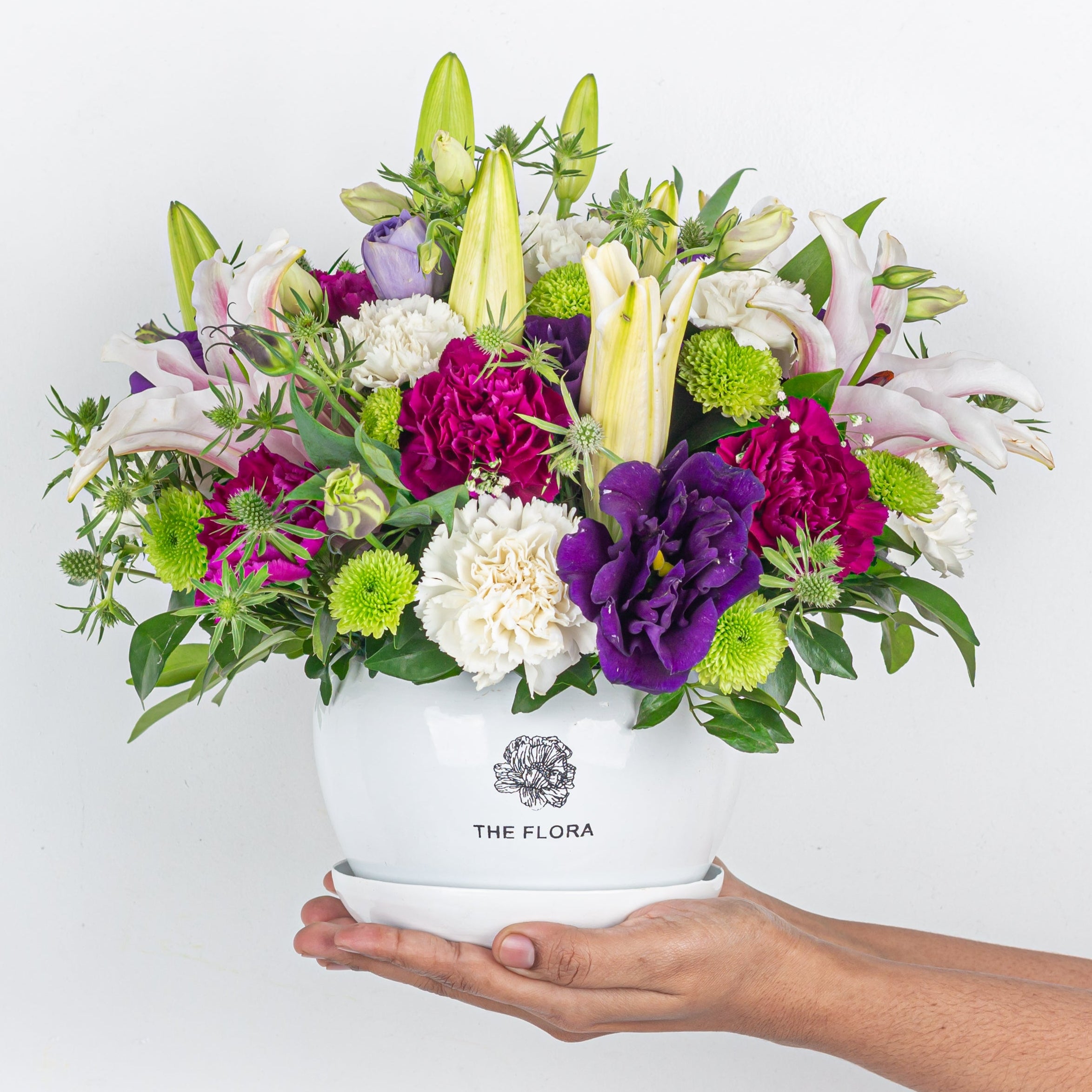 Lifestyle: "Blush pink carnations button chrysanthemums anniversary floral decor" metal pot with flora logo in hand