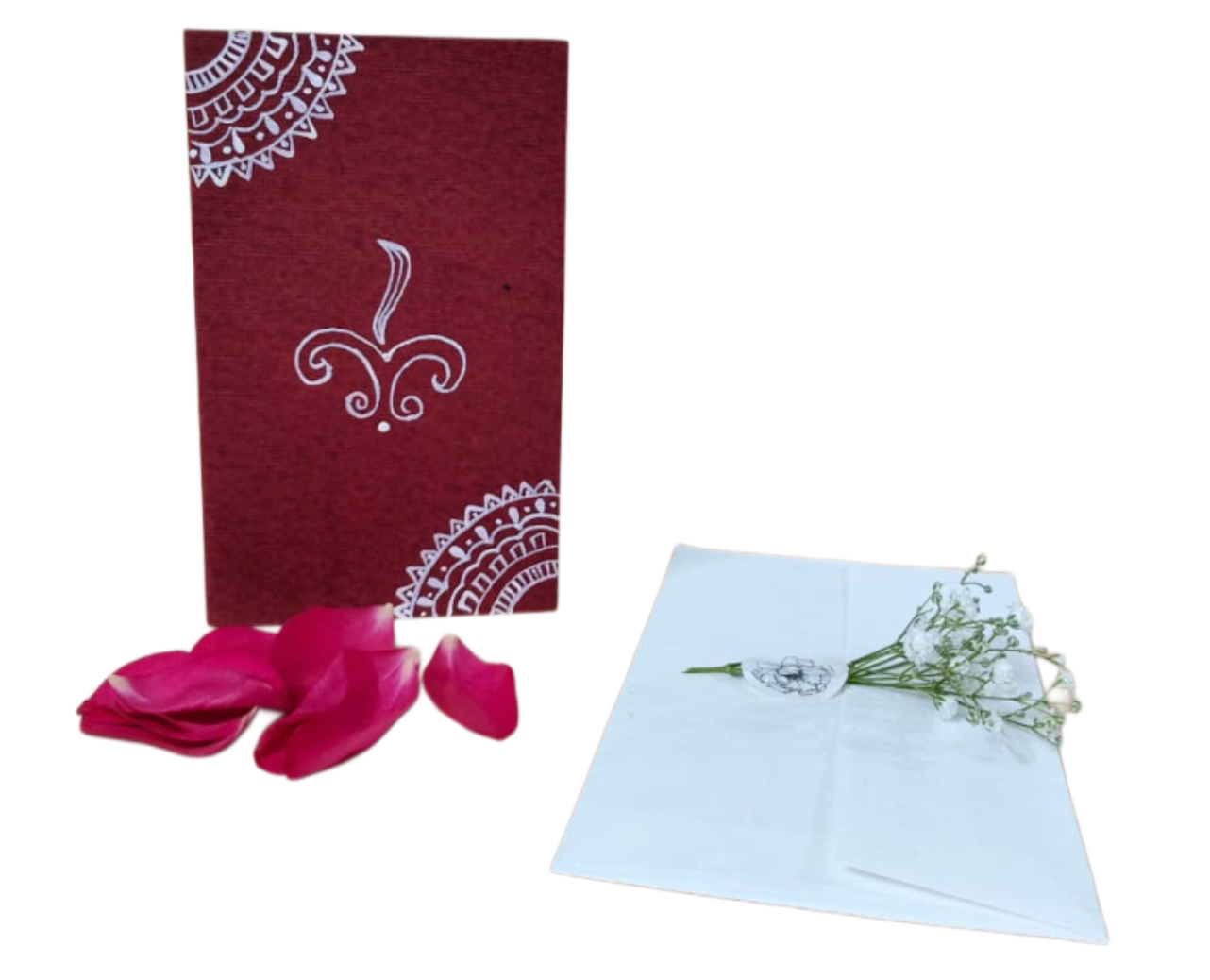 rakshabandhan traditional card with white design, pink rose petals, and a light blue card with flowers on a white background